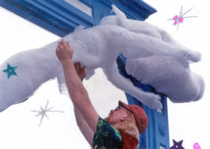 An image from the FAC scrapbooks – Dave McKay installing a cloud on a Solstice Parade float in 1993. Photo provided by the FAC and Michael Falcone