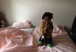 One of the recipients of the Beds for Kids program, enjoying her own bed for the first time in her life.  Photo provided by Seattle Police Foundation